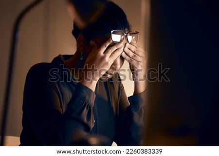 Stress, burnout and business black woman at night working on project, report and strategy deadline. Headache, mental health and female in dark office frustrated, tired and work problem on computer Royalty-Free Stock Photo #2260383339