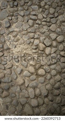 stone background, small stones arranged for a street and this photo is taken from a top viewpoint.
