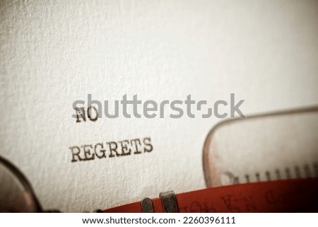 No regrets text written with a typewriter. Royalty-Free Stock Photo #2260396111