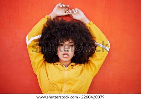 Portrait, fierce and black woman with attitude, power and empowerment with afro on studio background. Face, African American female creative and lady with confidence, casual outfit and motivation Royalty-Free Stock Photo #2260420379