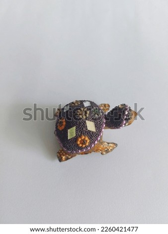 Miniature wooden turtle with pearl and glass ornaments