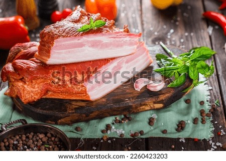 Meat delicacy, boiled pork beautiful, whole or sliced on a kitchen cutting board, spices and vegetables, dark and moody, clouseup on a black wooden isolated background, top	
 Royalty-Free Stock Photo #2260423203
