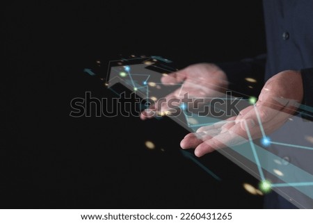 Business goes to the next level. Both hands support the virtual arrow with light paths. Isolated on black background. Manipulation concept.
