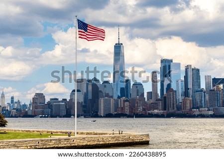 Panoramic view of Manhattan cityscape and USA flag in New York City at sunset, NY, USA Royalty-Free Stock Photo #2260438895
