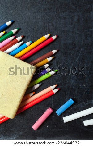 School supplies concept on blackboard background ready for your design.