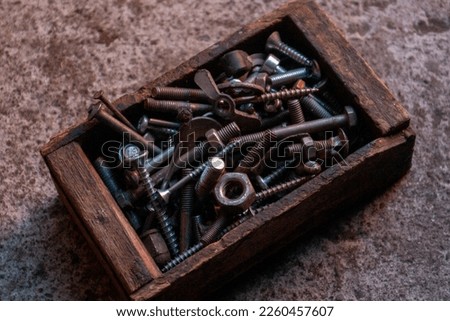 Box with bolts, nuts and nails Royalty-Free Stock Photo #2260457607
