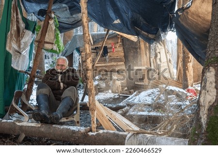 Old man in his camp in the forest. For many pensioners, retirement is a poverty trap. The politicians ensure that you can no longer live as a pensioner in Germany. Royalty-Free Stock Photo #2260466529
