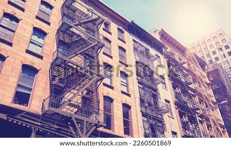 Color toned picture of buildings with fire escapes, New York City, USA.