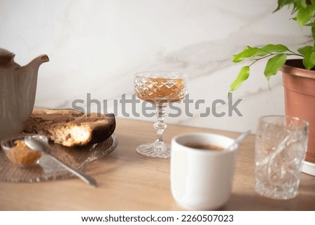 
the table is served with apple pie and jam with a coffee drink