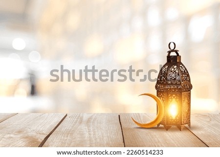 Ornamental Arabic lantern with burning candle glowing . Festive greeting card, invitation for Muslim holy month Ramadan Kareem. Ramadan Kareem greeting photo with serene mosque background.
 Royalty-Free Stock Photo #2260514233