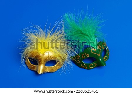 Multicolored carnival mask on blue background. Purim.