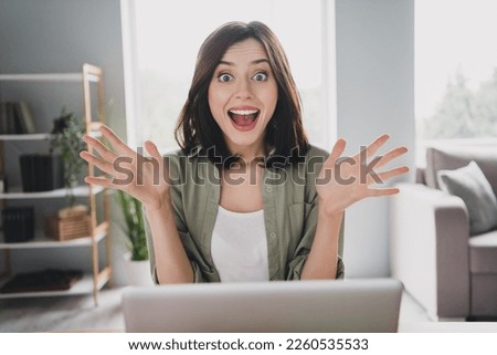 Photo of astonished overjoyed girl pen mouth raise arms cant believe use netbook workstation indoors