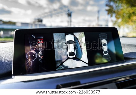 Parking assistance screen of luxury car, sunny day Royalty-Free Stock Photo #226053577