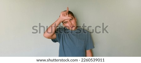 A Man making loser sign with space for text