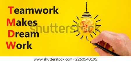 TMDW Teamwork makes dream work symbol. Concept words TMDW Teamwork makes dream work on yellow paper on beautiful yellow background. Business TMWD teamwork makes dream work concept. Copy space.