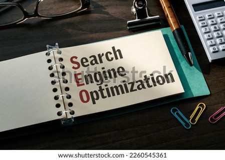 There is a notebook with the word Search Engine Optimization. It is an eye-catching image.
