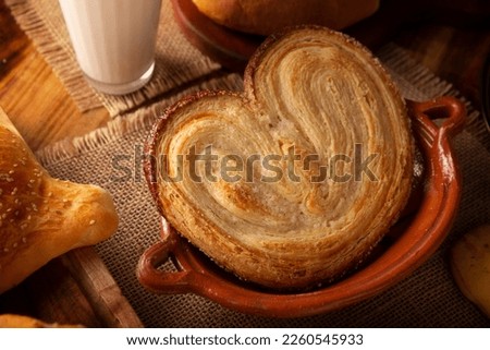 Oreja. Mexican sweet bread made with puff pastry, its name comes from its shape similar to that of ears, of French origin, where it is known as Elephant Ear or Palmier Puff Pastry. Royalty-Free Stock Photo #2260545933