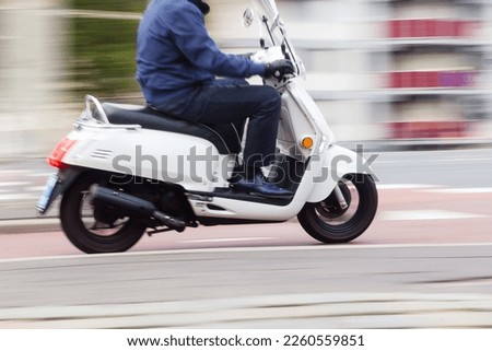 motor scooter in city traffic in motion blur