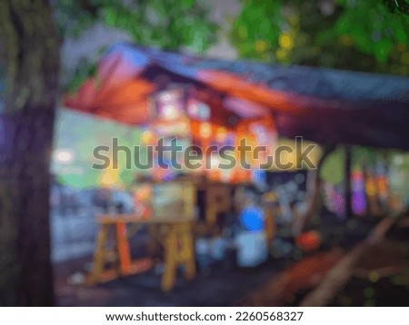 Defocused and Abstract Background of a roadside coffee shop at night