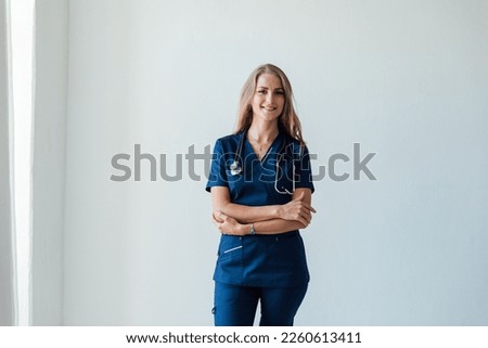 a woman in medical uniform doctor with phonendoscope in hospital