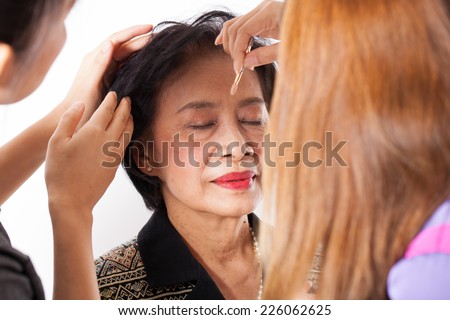 make-up senior woman, female Asian with make-up artists cosmetic