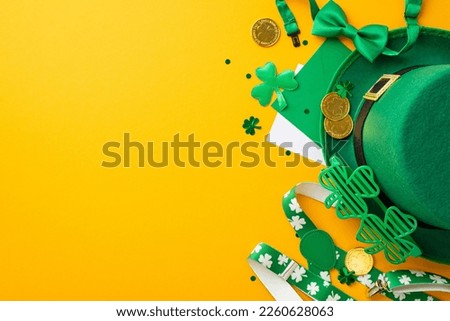 Top view photo of St Patrick's Day accessories leprechaun hat suspenders gold coins envelope letter clovers trefoil shaped party glasses bow-tie confetti on isolated yellow background with copyspace