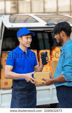 Delivery man asia people checking portable delivery device with parcel box to customer home address. give delivery box to customer and sign a signature of receiver people
