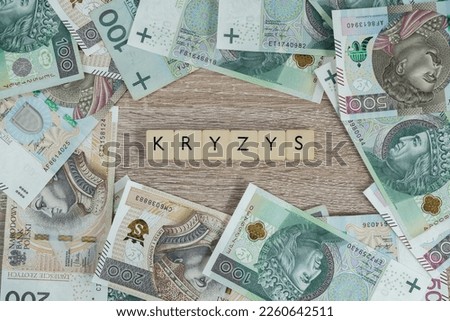 Kryzys in Polish language means crisis. Inflation and rising prices in Poland and rest of Europe. Flat lay concept with Polish złoty money, PLN zloty banknotes.