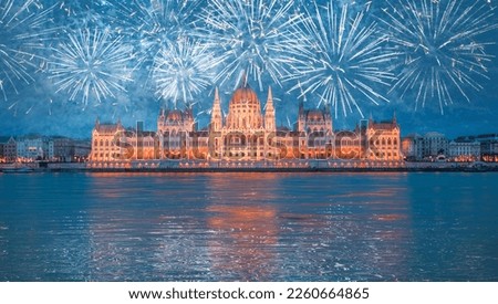 Hungarian parliament with fireworks in Budapest at twilight blue hour - Budapest, Hungary