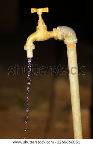 a vintage villages still water tap, with original pure water. picture captured at night 