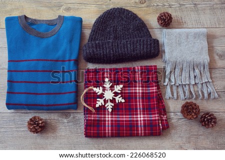 Winter clothes on wooden background. View from above 