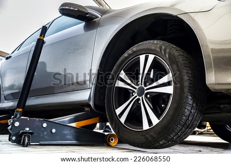 Tire replacement service, fitting with balancing, change to winter Royalty-Free Stock Photo #226068550