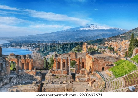 Ruins of ancient Greek theater in Taormina and Etna volcano in the background. Coast of Giardini-Naxos bay, Sicily, Italy, Europe. Royalty-Free Stock Photo #2260697671