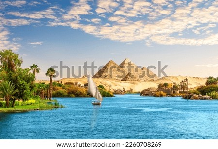 Beautiful Nile scenery  with sailboat in the Nile on the way to pyramids, Aswan, Egypt Royalty-Free Stock Photo #2260708269