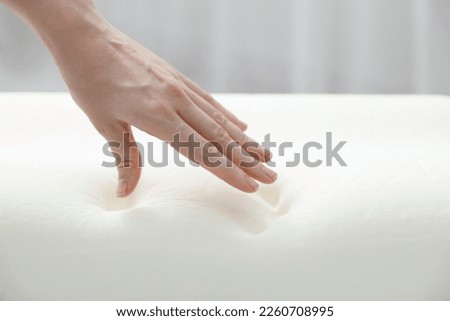 Woman with memory foam pillow indoors, closeup. Space for text Royalty-Free Stock Photo #2260708995