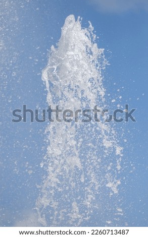 splashing water from a fountain against the blue sky