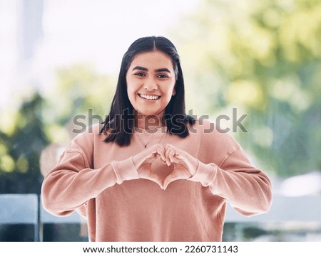 Portrait, heart hands and young woman for self care, cardiology wellness and gen z support for women health. Face of a happy Indian person with love emoji, sign or gesture for like, vote and peace Royalty-Free Stock Photo #2260731143