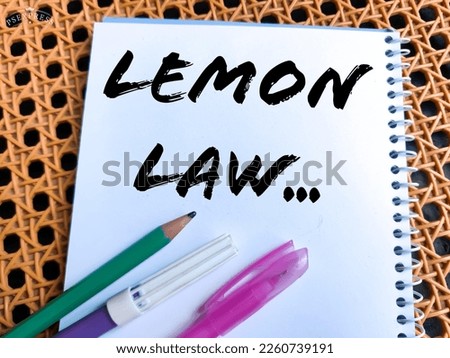 Concept of Lemon Law write on sticky notes with pencil isolated on Wooden Table.