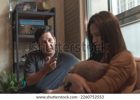 A man tries to justify his actions to his upset wife. Marital problems and disagreements in a couple. Royalty-Free Stock Photo #2260752553