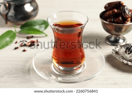Tea in glass and vintage tea set on wooden table