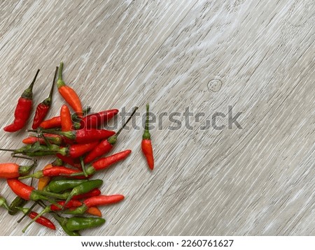 Fresh red and green chili on the floor. Hot and spicy vegetable. Copy space for text image.