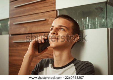 adorable boy talks on the phone