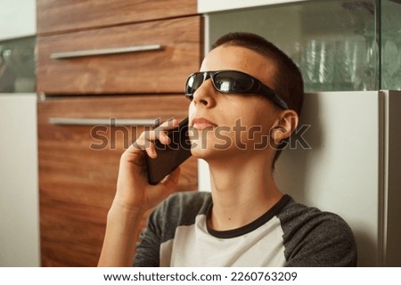 adorable boy talks on the phone