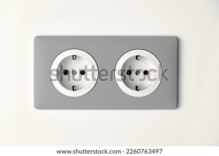 Stylish gray Electric Outlet. Power outlet on the wall. Euro type electric outlet on wall. Royalty-Free Stock Photo #2260763497