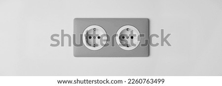 Stylish gray Electric Outlet. Power outlet on the wall. Euro type electric outlet on wall. Royalty-Free Stock Photo #2260763499