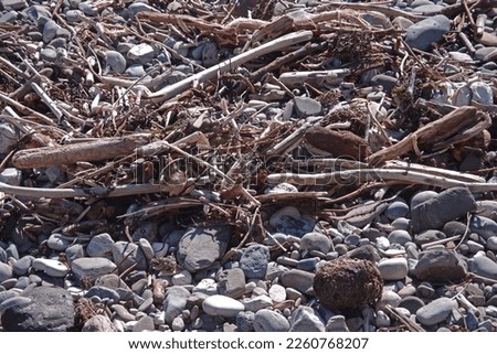 Rocks and debris on a pacific ocean beach after heavy winter storms