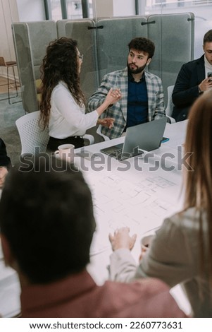 A photo of a beautiful couple having a conversation in the meeting room