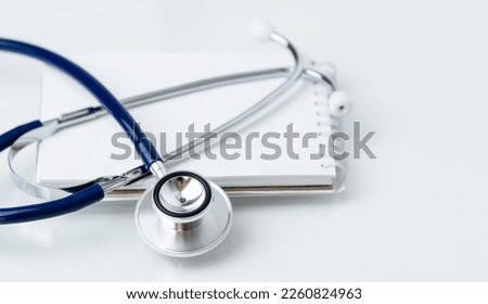Stethoscope on white notepad with copy space.