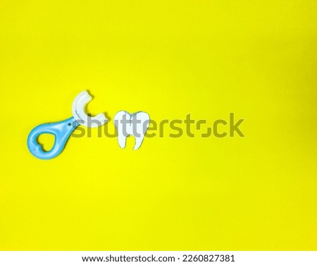 children's toothbrush for the prevention of dental caries, on a yellow background, top view