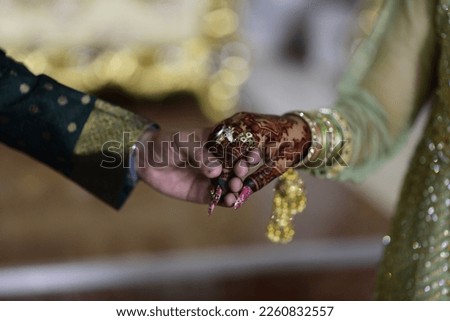 Bride and Groom's Hand Being Tied Together Before the Wedding Rituals Royalty-Free Stock Photo #2260832557